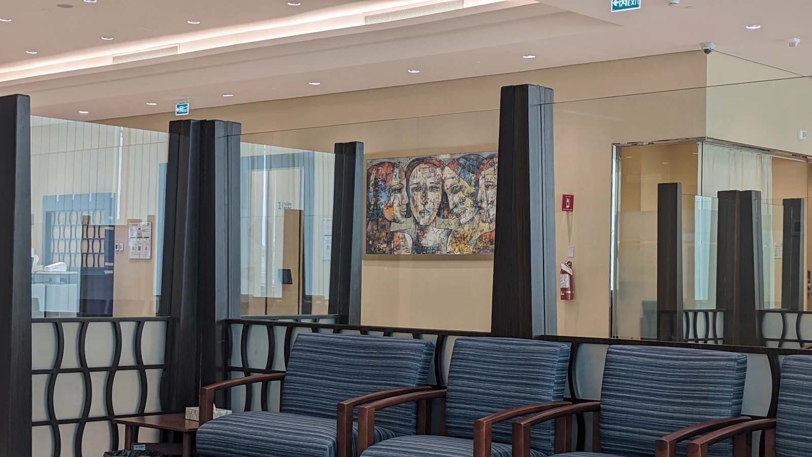 Modern waiting room with blue chairs and abstract art