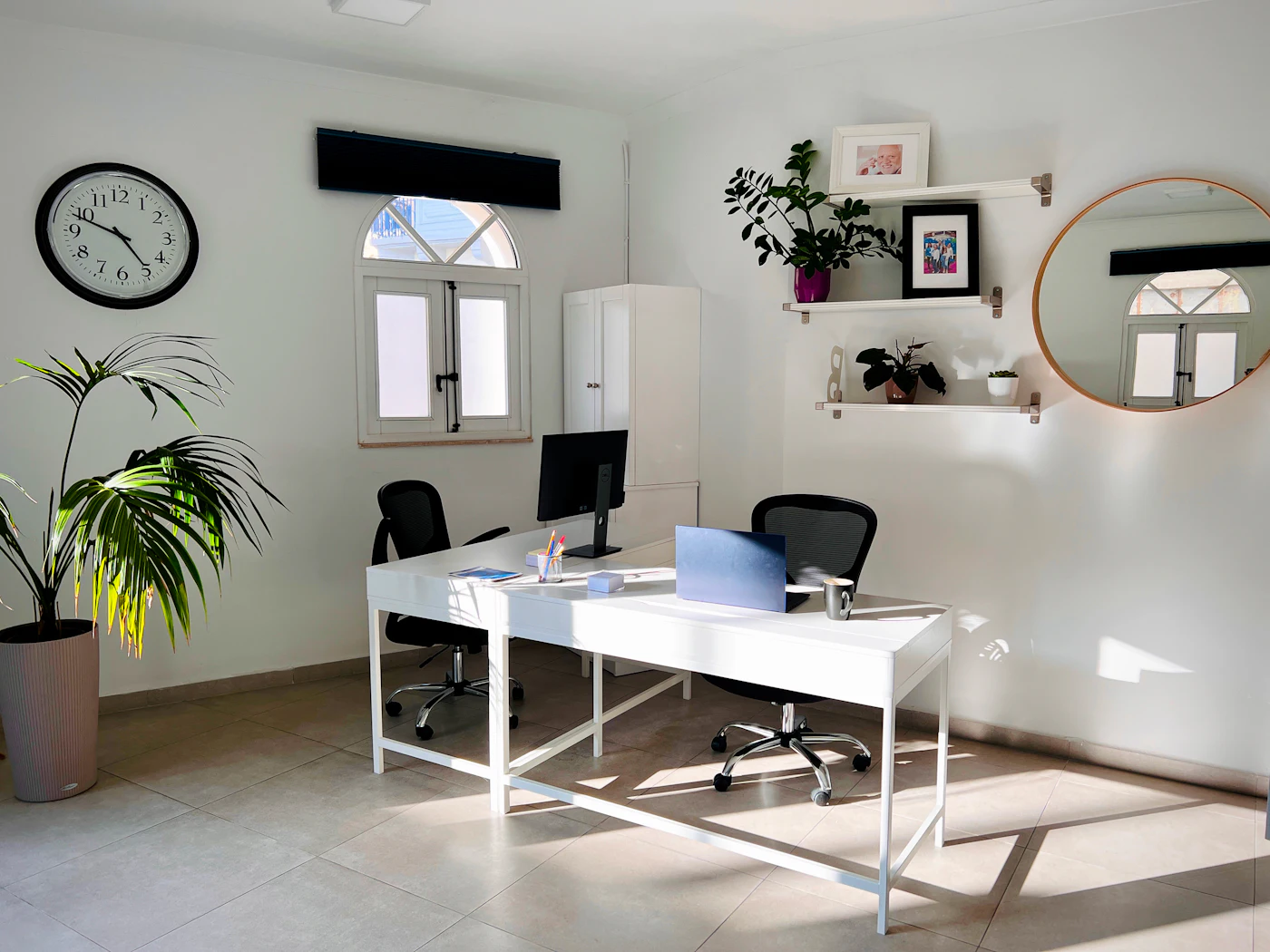 Modern office with two desks and plants — photo by FlippingBook on Unsplash