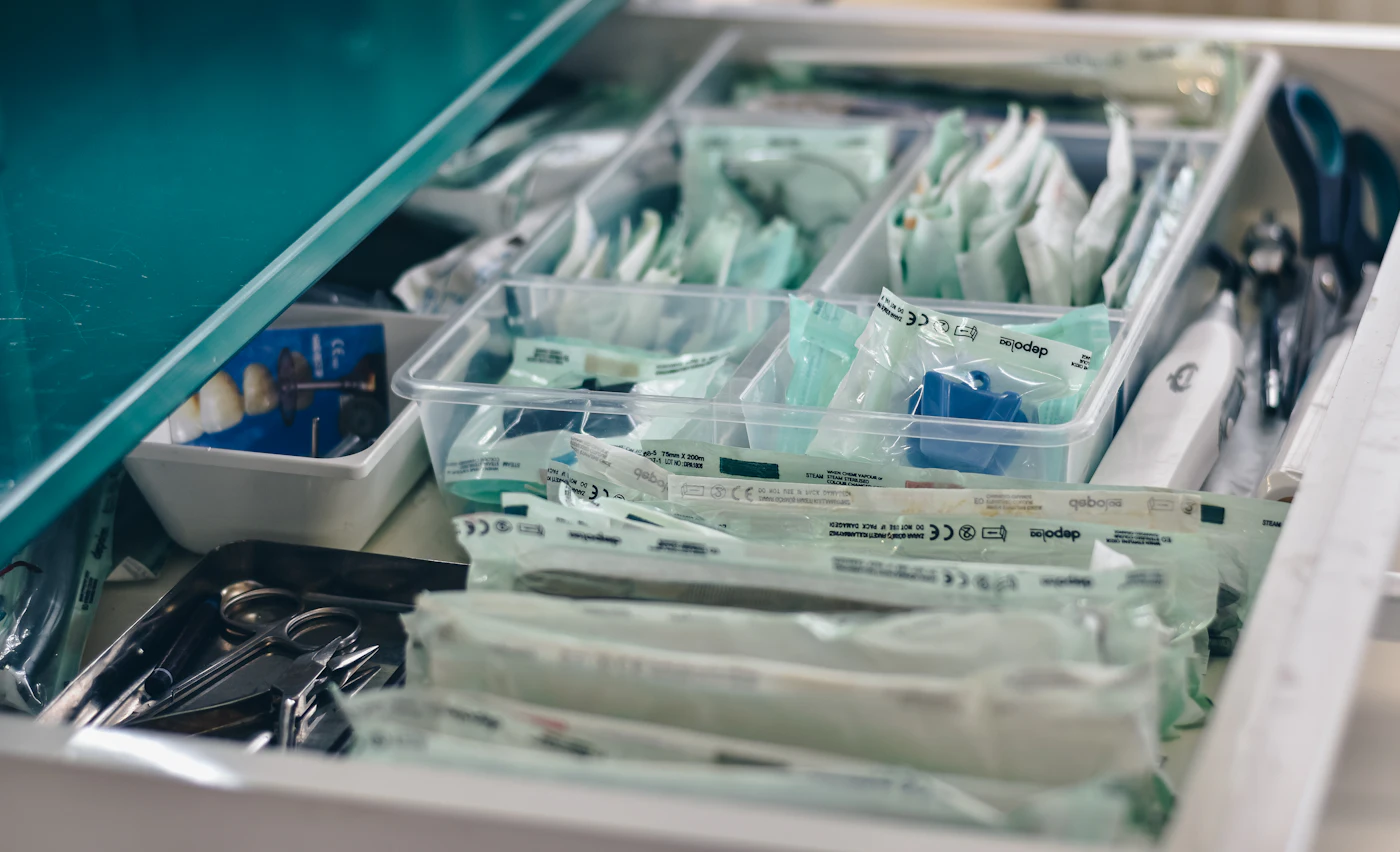white packs with scissors and medicine on gray tray — photo by Ibrahim Boran on Unsplash