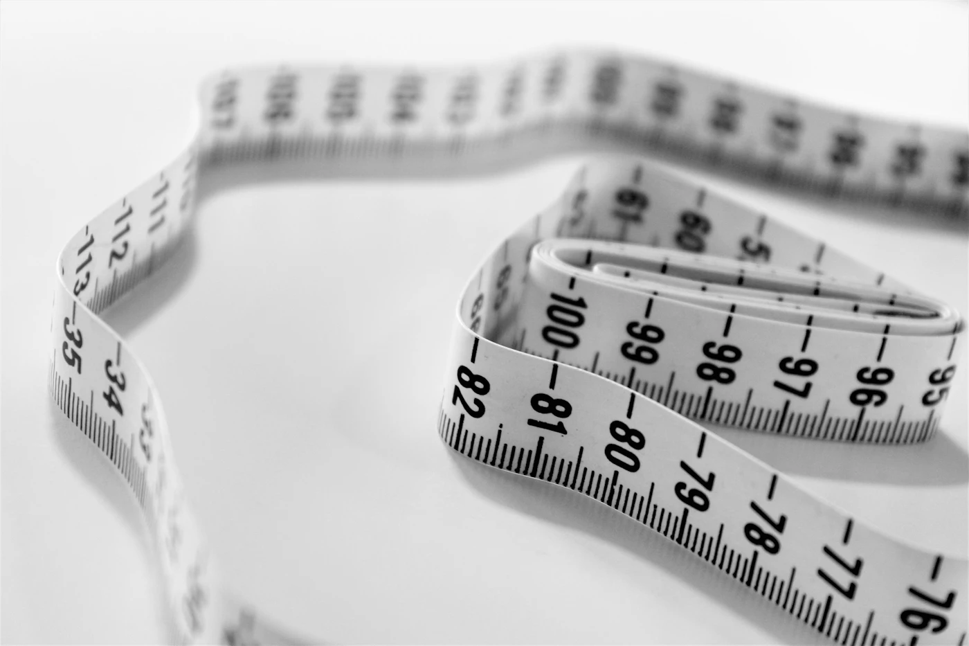 selective focus photography of tape measure — photo by Siora Photography on Unsplash